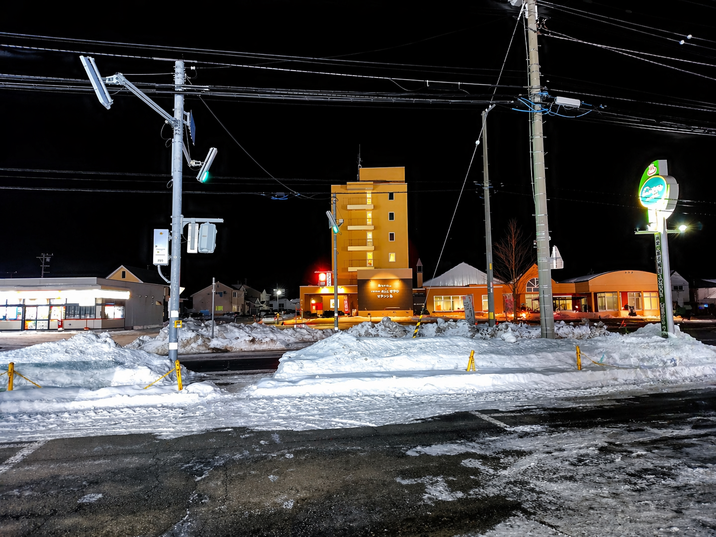 夜のホテルモアン外観、雪道と温泉看板